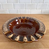 Top view showing horse motif, drip glaze and rim detail