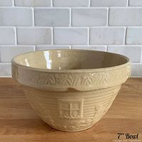 Overall view of yellow ware mixing bowl exterior with embossed motif visible