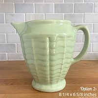 front view of mint green wave pitcher showing handle and spout