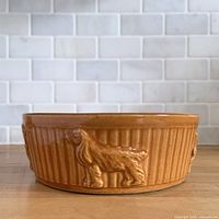 Side view showing embossed dog figure and ribbed texture