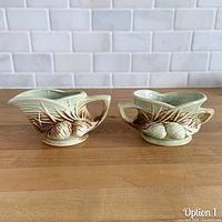 Front view of McCoy Pinecone creamer and sugar set showing relief design and glaze