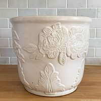 Front view of ivory planter showing rose relief pattern