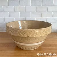 Overall view of yellow ware mixing bowl showing decorative banding and red/white stripe