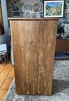 right side of pine cabinet showing single wide board construction and wood grain