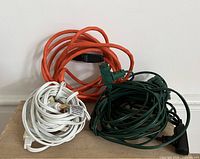 Group shot of orange, white, and green cords coiled
