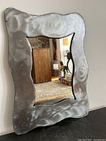 Front view of mirror showing entire steel frame and glass