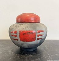 Front view showing overall form, red and grey glaze pattern