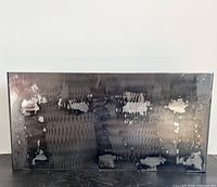 front view of rectangular steel planter showing grind patterns and patina