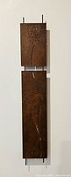 Full view of two-panel rusted steel wall sculpture