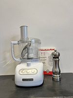 Food processor assembled with pepper grinder and manual