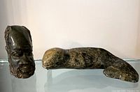 Both stone sculptures side by side on shelf