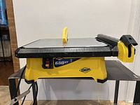 Front view of QEP 650XT wet tile saw showing main body, power switch and QEP logo