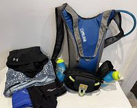 All items together: CamelBak pack, Nathan belt with bottles, four shorts