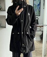 Front view of black Hillary Radley coat worn, showing length, pockets, hood