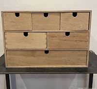 Front view of six-drawer unfinished plywood cabinet
