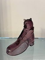 Front three-quarter view of amethyst pressed glass Puss in Boots figurine