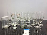 Group shot of all thirteen clear glass pieces on countertop