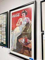 Full view of framed Coca-Cola poster on wall