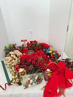 Overall lot showing florals, ornaments, lights, bells, ribbon