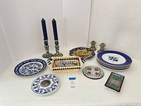 Full lot showing plates, candlesticks, basket, napkin rings, candles