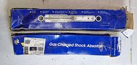 Two blue rectangular boxes labeled Gas Charged Shock Absorber, showing relative sizes and wear