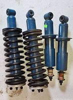 Front view of two coil-over and two standard shocks