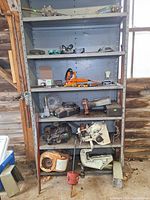 Full view of shelving unit with assorted tools and parts