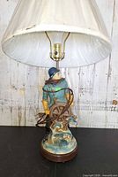 Lamp assembled with shade showing figurine base
