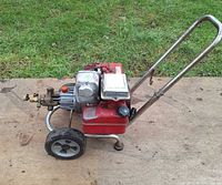 Side view showing engine, pump, tank, wheels, manifold