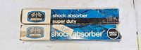 Two Armstrong shock absorber boxes stacked