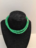 Necklace displayed doubled on black bust showing bead color and clasp