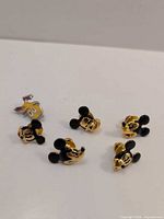 Front view of six Disney Napier enamel lapel pins