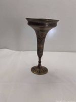 Full view of etched brass vase on white background