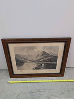 Full view of framed landscape print with measuring tape for scale