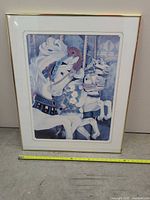 Front view of framed, matted carousel horse print with measuring tape for scale