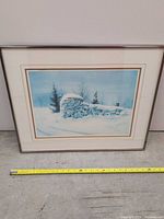 Front view of framed winter landscape print with tape measure for scale