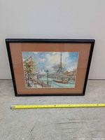 Front view of framed print with measuring tape for scale