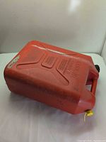 Top and side view of red 20-L plastic gas can with handle and caps