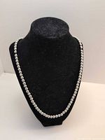 Full view of beaded necklace on display bust