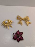 All three brooches together