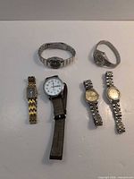 Six watches laid out showing variety of styles and bands