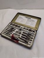 open case showing full 24-piece tap and die set layout