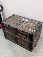 Closed trunk showing wood slats and metal banding