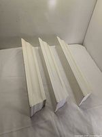 Three white floating shelves laid flat, top view