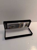 Open case displaying pens