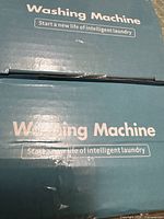 Front of two product boxes labeled Washing Machine