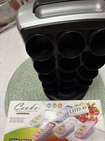 Full view of pod tower next to boxed Cooko grater