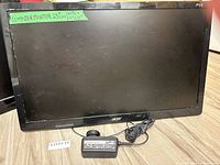 Front view of Acer monitor with stand and power adapter