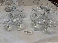 Ten clear stemmed glasses arranged to show quantity and style