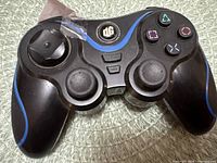 Front view of DreamGEAR controller showing buttons, analog sticks, logo